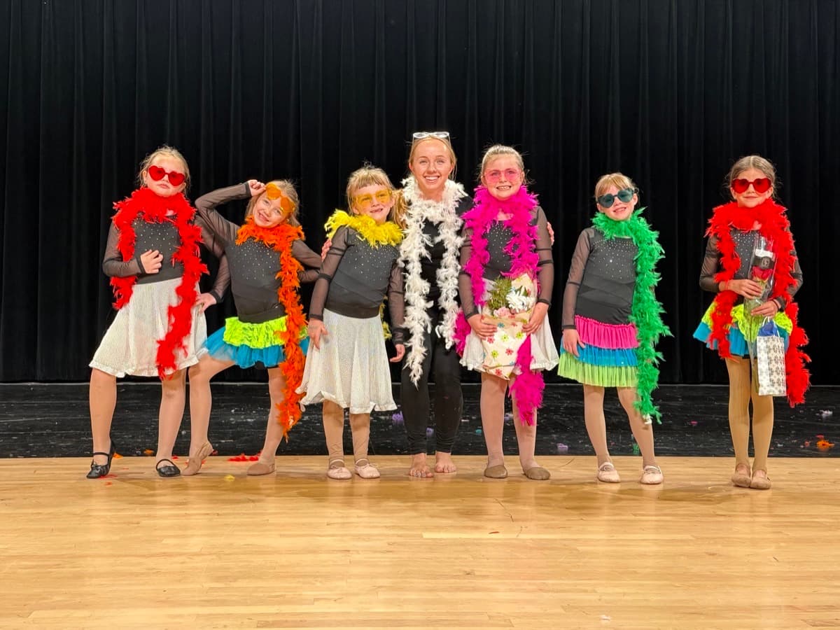 Skyward Dance Studio recreational dancers celebrating on stage after a performance